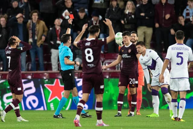 Hearts defender Lewis Neilson is sent off for tugging the shirt of Fiorentina's Luka Jovic.