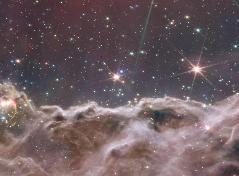 This image shows the edge of a nearby, young, star-forming region called NGC 3324 in the Carina Nebula. It reveals for the first time previously invisible areas of star birth.