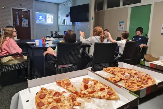 Covid-19 Community Award winners, Amazing Brains Committee at Art Club, having a night together watching the awards and eating pizza.