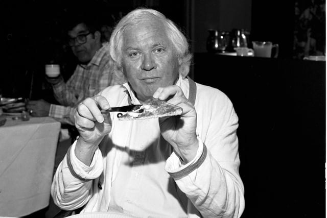 Maverick British film director Ken Russell butters a slice of breakfast toast in an Edinburgh hotel in August 1987.