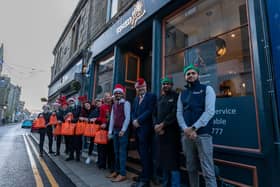 Bo'ness Spice owner Mohammad Abbas (maroon top) and team, local MP Martyn Day and the Dalriada Home Care staff.

Picture: MB Media.