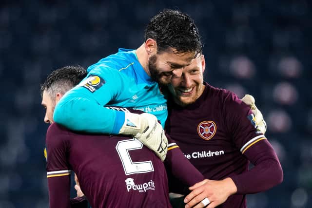 Hearts Michael Smith and Craig Halkett celebrates with Craig Gordon.