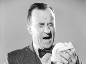 Remember, coughs and sneezes spread diseases, so please try to use a handkerchief (Picture: Fox Photos/Getty Images)