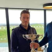The Renaissance Club's Ross Noon, left, is presented with The Uniroyal Trophy by Edinburgh & East of Scotland Golfers' Alliance president Donny Munro after his win at Gullane earlier in the year.