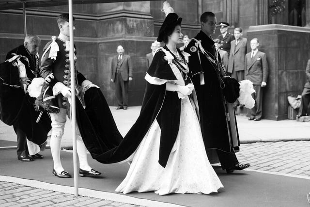 Queen Elizabeth II and the Duke of Edinburgh walking to the Signet Library from St Giles' Cathedral after a service on her coronation visit to Edinburgh in 1953. She was only 27 years old when she was crowned Queen of the United Kingdom.