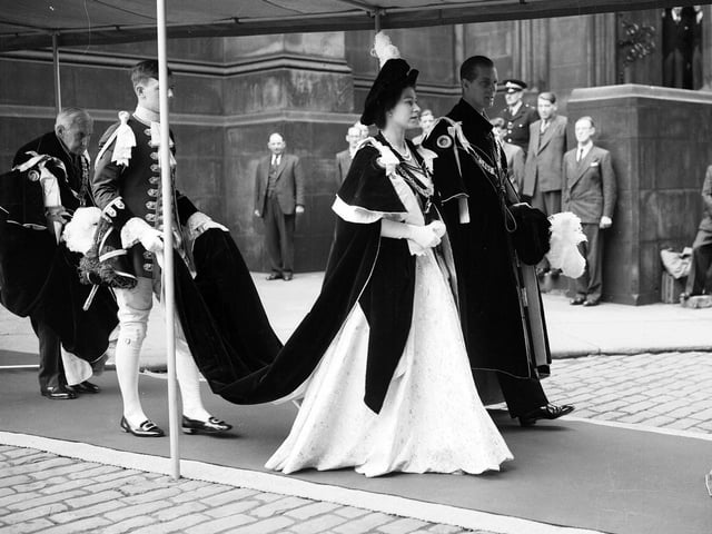 Queen Elizabeth II and the Duke of Edinburgh walking to the Signet Library from St Giles' Cathedral after a service on her coronation visit to Edinburgh in 1953. She was only 27 years old when she was crowned Queen of the United Kingdom.