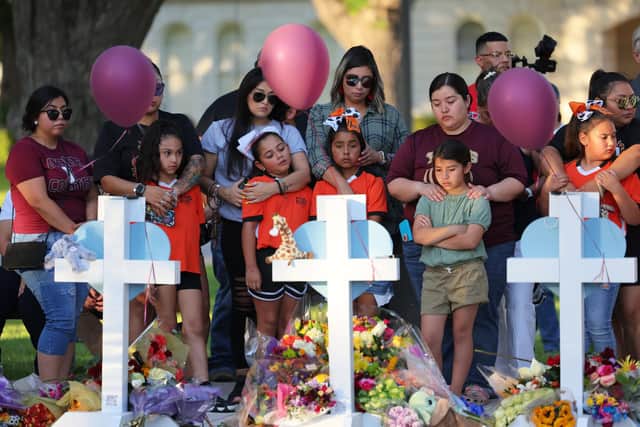 UVALDE, TEXAS - MAY 26: People visit memorials for victims of Tuesday's mass shooting at a Texas elementary school, in City of Uvalde Town Square on May 26, 2022 in Uvalde, Texas. (Photo by Michael M. Santiago/Getty Images)