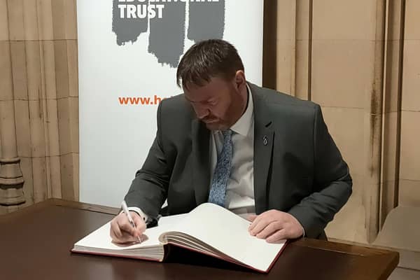 Owen Thompson MP signing the Holocaust Educational Trust’s Book of Commitment.