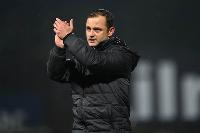 Hibs boss Shaun Maloney applauds the travelling fans at full time at Dens Park