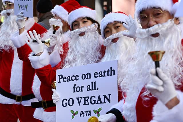 Protesters dressed as Santa Claus urge people to go vegan (Picture: Richard A Brooks/AFP via Getty Images)