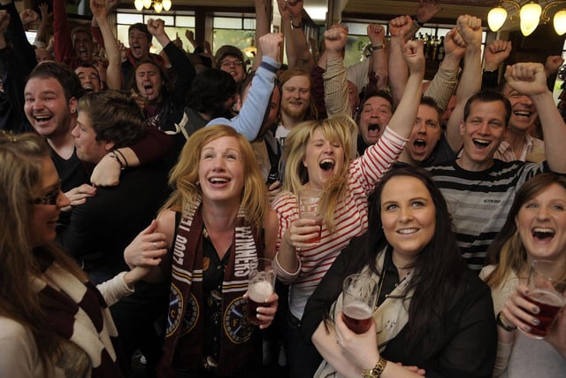 Hearts fans watch and celebrate Hearts win over Hibs in the Scottish Cup Final at 'Diggers' the Athletic Arms at Ardmillan in Gorgie in 2012, their last major honour.