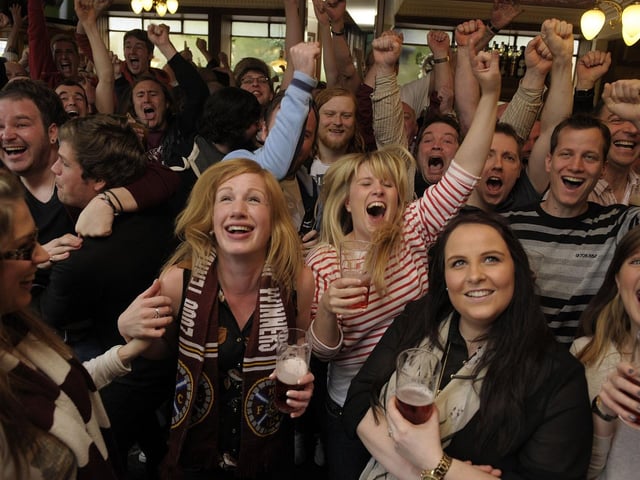 Hearts fans watch and celebrate Hearts win over Hibs in the Scottish Cup Final at 'Diggers' the Athletic Arms at Ardmillan in Gorgie in 2012, their last major honour.