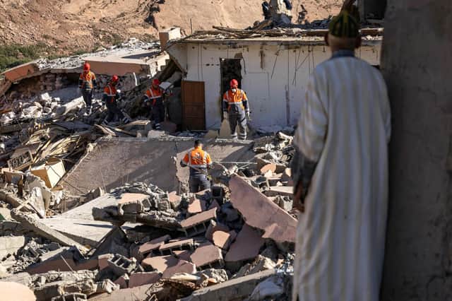 Volunteers search for survivors in the rubble in the village of Talat N'Yacoub, south of Marrakech on Monday. The quake killed at least 2,122 people, injured more than 2,400 others, and flattened entire villages (Picture: Fadel Senna/AFP/Getty Images)