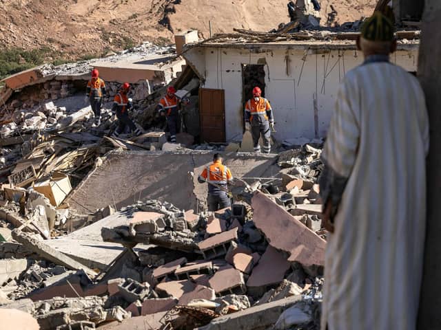 Volunteers search for survivors in the rubble in the village of Talat N'Yacoub, south of Marrakech on Monday. The quake killed at least 2,122 people, injured more than 2,400 others, and flattened entire villages (Picture: Fadel Senna/AFP/Getty Images)