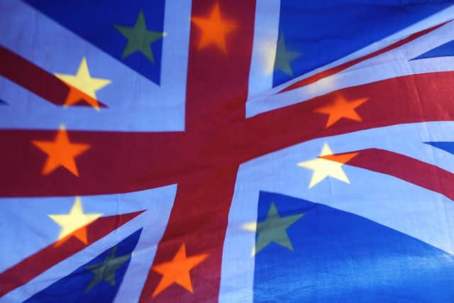 File photo of an EU and Union flag held aloft in Westminster, London.