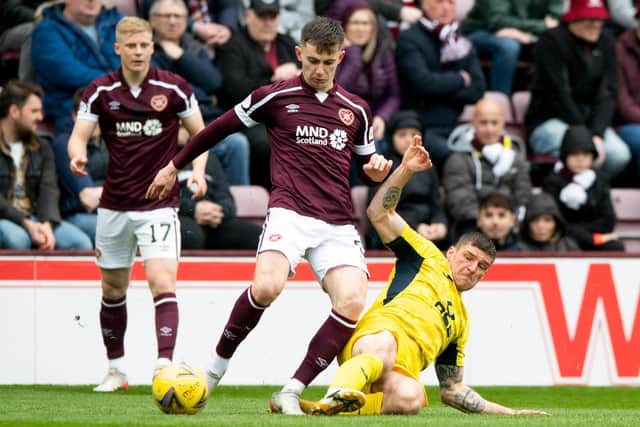 Ross County midfielder Ross Callachan tackles Hearts' Ben Woodburn during the 0-0 draw at Tynecastle Park. Picture: SNS