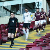 Hearts emerge from the temporary away dressing room at Fir Park.