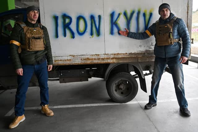 Kyiv mayor Vitali Klitschko, right, and his brother Wladimir Klitschko visit a check-point on the outskirts of the Ukrainian capital (Picture: Genya Savilov/AFP via Getty Images)