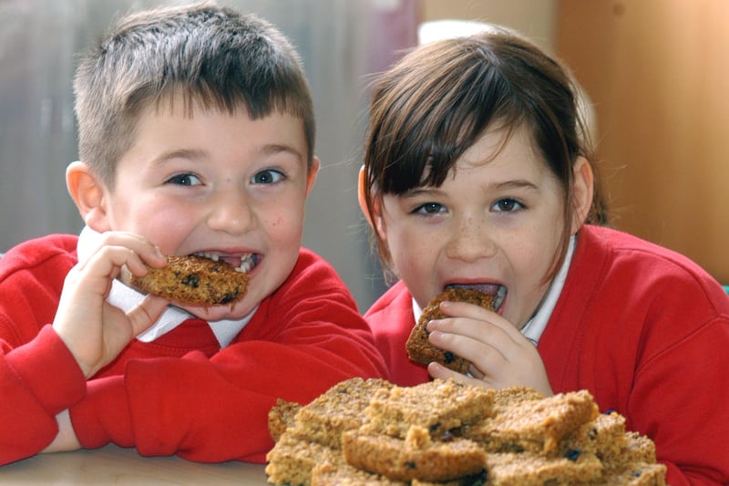 Riley Patterson and Natasha Loughlin try out flapjacks which were baked by pupils at Camden Square Infants School in 2007 for Comic Relief.