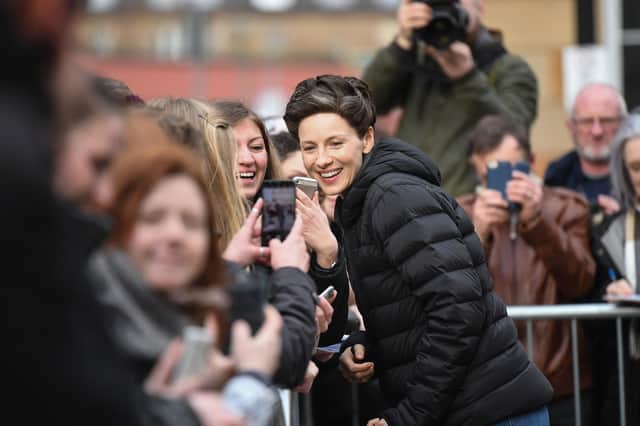 Outlander star Caitriona Balfe takes a break from filming to pose for pictures with fans (Picture: Jeff J Mitchell/Getty Images)