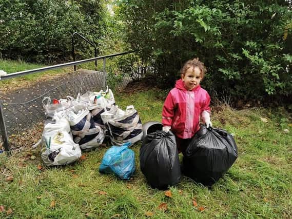 Three-year-old Lizzy Miteva is working hard to tidy up her local area.