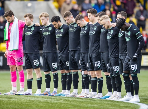The Hibs players line up for a minute's silence in honour of Gordon before the Livingston game