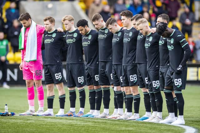 The Hibs players line up for a minute's silence in honour of Gordon before the Livingston game