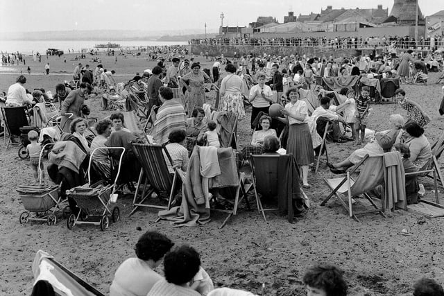 Glasgow Fair holidaymakers on Portobello Beach, with the Buchan Pottery kilns in the background, in July 1961.