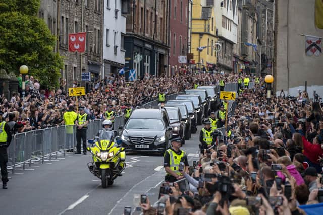 The hearse carrying the coffin of Her Majesty Queen Elizabeth is seen travelling along The Royal Mile in Edinburgh
