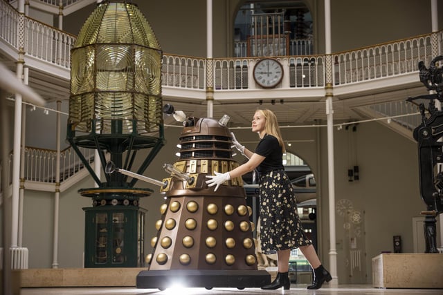 Liv Mullen wheels a Dalek into the National Museum of Scotland ahead of major exhibition. Photo credit: Duncan McGlynn