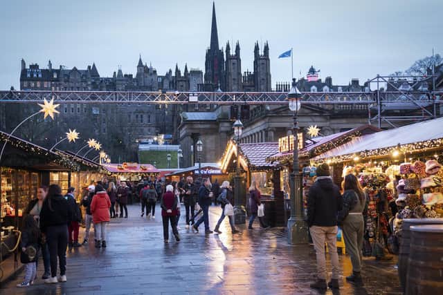 Shoppers at the Christmas Market on Edinburgh's Princes Street during New Year's Eve 2021. Photo by Jane Barlow/ PA.