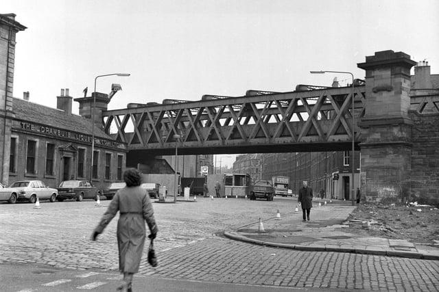 The disused railway bridge at Easter Road was dismantled in January 1980. Also in picture, The Drambuie Liqueur Co Ltd sign.