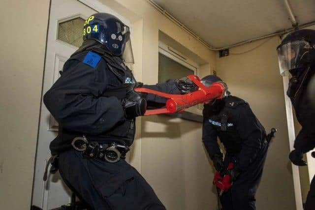 Poilce carrying out a raid during Operation Venetic - the biggest ever UK operation into serious and organised crime involving Police Scotland, the National Crime Agency (NCA) and police forces across the country.