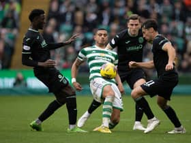 Paul Hanlon attempts to thwart Celtic striker Giorgos Giakoumakis alongside Hibs colleagues Nohan Kenneh, left, and Joe Newell