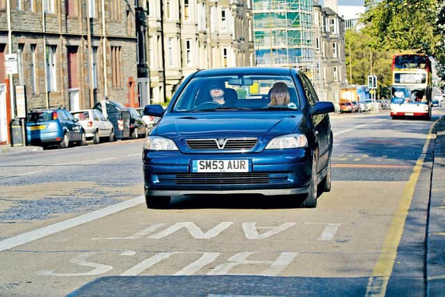 A car drives in a bus lane in London Road - the council brought in over £2 million in 2022/23 from fines on motorists who drove in bus lanes.  Picture: Rob McDougall.