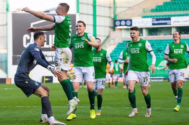 Ryan Porteous celebrates with his Hibs team-mates after scoring the winning penalty against Motherwell. Picture: SNS