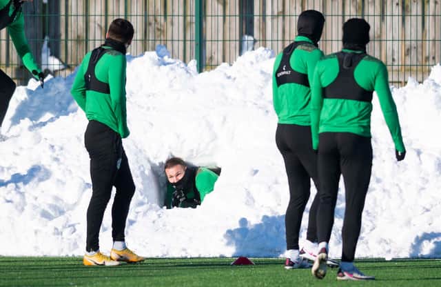 Martin Boyle carries out an in-depth pitch inspection of his own at Hibs' East Mains training complex