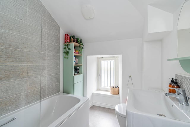 The master bedroom's stylish en suite bathroom comes with a crisp three-piece suite with a shower over the bath.