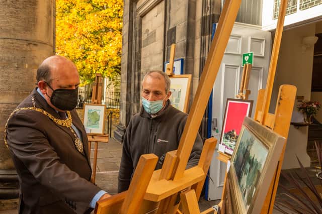 The Lord Provost admires some of the paintings at Christian Aid's sale of pictures with James Holloway, former director of the Scottish National Portrait Gallery, who is pictures convener for the sale.