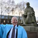 The late Professor Peter Higgs poses for photographs in front of a statue of James Watt, after receiving an honorary degree from Heriot-Watt University in 2012 (Picture: Jeff J Mitchell/Getty Images)