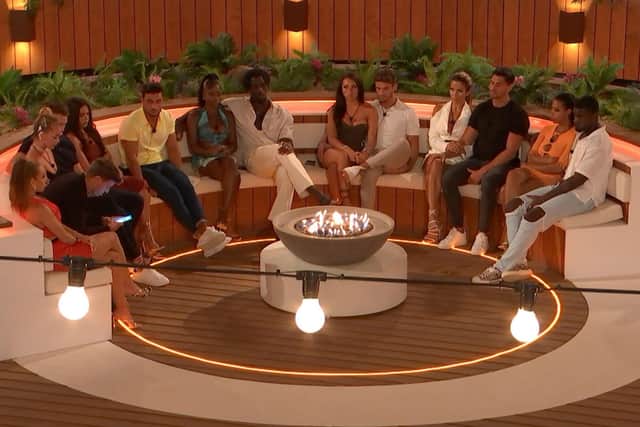 The Islanders gathered around the firepit to learn the results of the public vote. Photo: ITV / Love Island.
