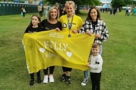 Cancer survivor Kelly McGowan from Bo'ness, pictured with her family after completing the Edinburgh Marathon.