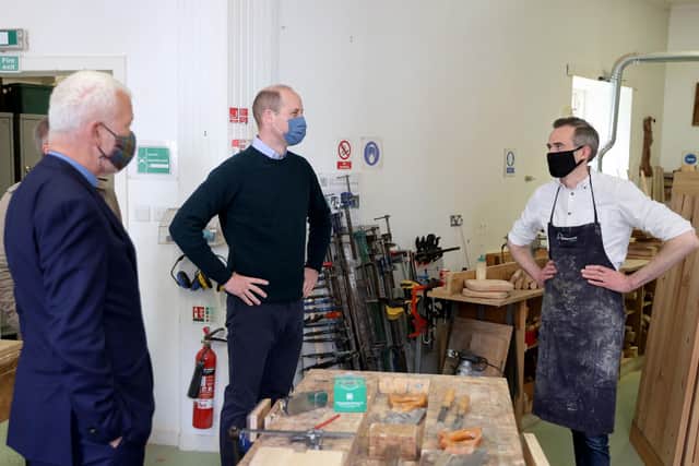 William, accompanied by Greyfriars Kirk minister, Richard Frazer (left), during a visit to the Grassmarket Community Project, in the centre's workshop, which makes furniture from recycled pews and other responsibly-resourced wood