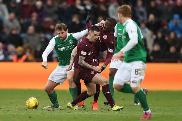 Holt in the thick of it against Arnaud Djoum and Jamie Walker of Hearts