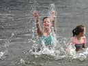 Two young girls cooling off in a loch in Scotland picture: John Devlin