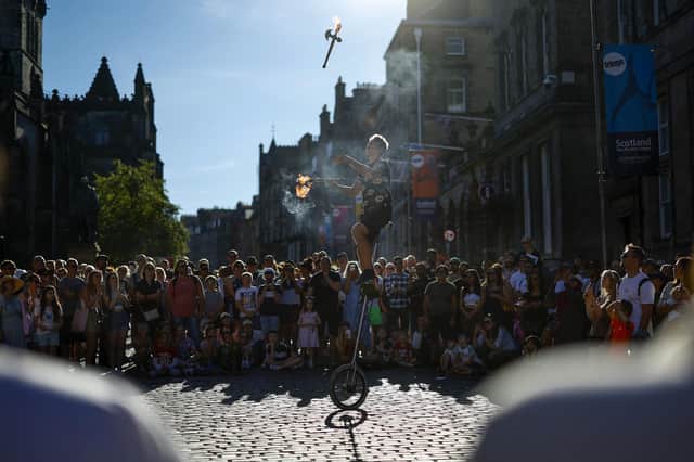 A street entertainer performs on Edinburgh's Royal Mile earlier this month (Picture: Jeff J Mitchell/Getty Images)