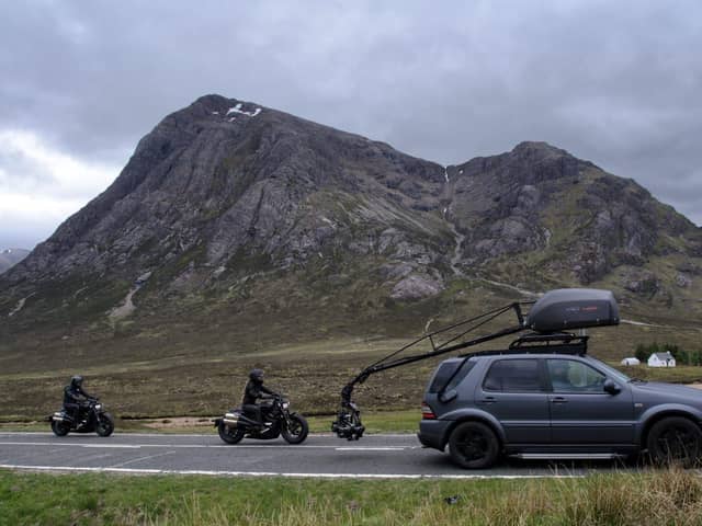 Two stunt workers can be seen racing each other on motorbikes, which appear to be from the World War Two era, behind a vehicle with a large camera rig. Photo: Tony Featherstone / SWNS.COM
