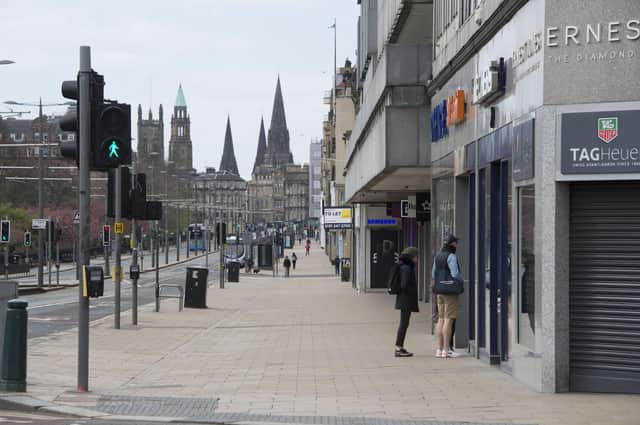 Edinburgh's Princes Street is nearly deserted at midday as people stick to the lockdown (Picture: Ian Rutherford)