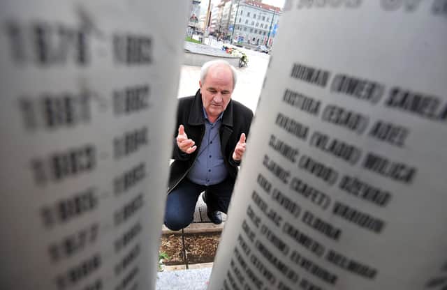 Ramiz Holjan, whose child Admir was one of 1,500 children killed during the siege of Sarajevo, prays at a monument bearing their names (Picture: Elvis Barukcic/AFP via Getty Images)