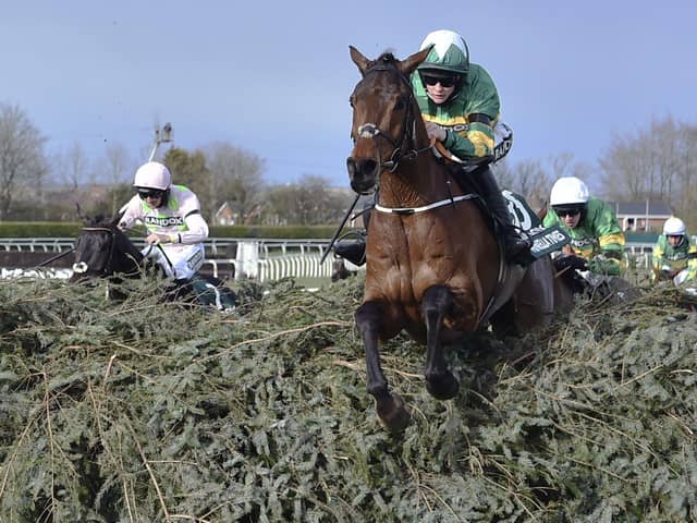 Rachael Blackmore riding Minella Times clears the last fence to win the Randox Grand National Handicap Chase in 2021. Photo: Peter Powell/Pool via AP, File.